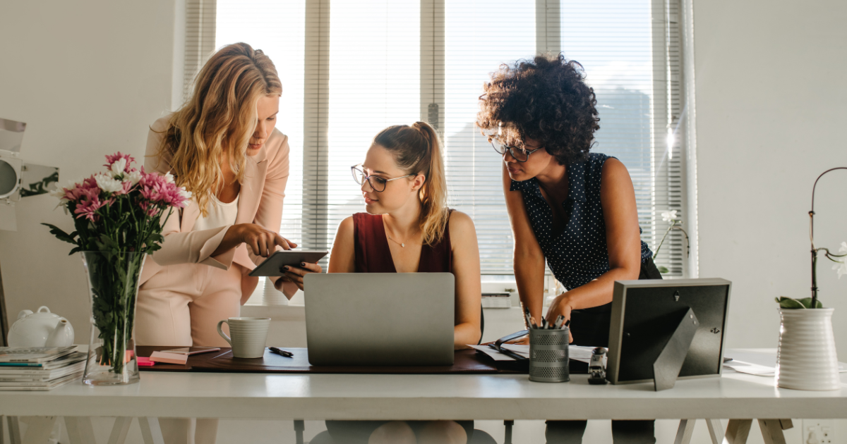 Three women working at small business office