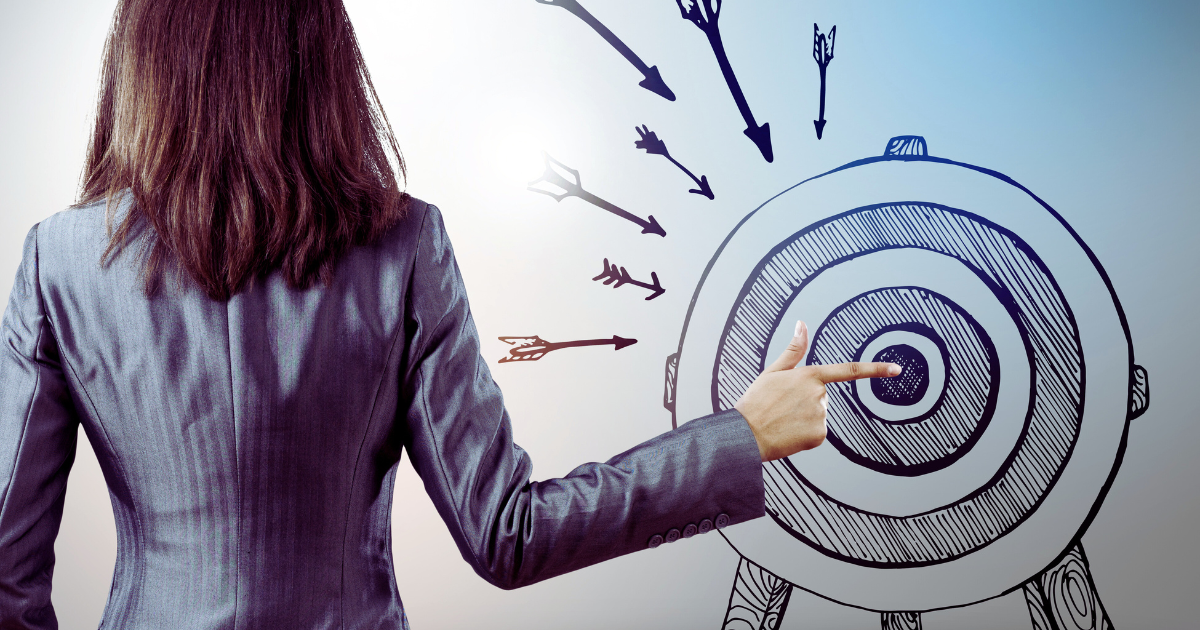 Woman demonstrating goal setting with bullseye graphic
